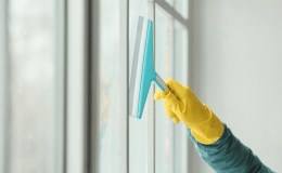 79747481 young man cleaning window home 1.png